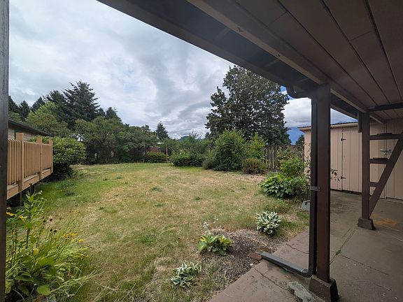 Backyard from covered area adjacent to garage.