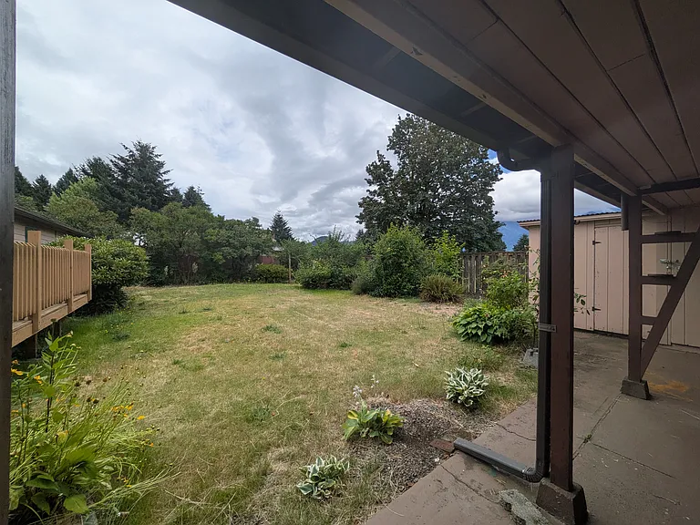 Backyard from covered area adjacent to garage.