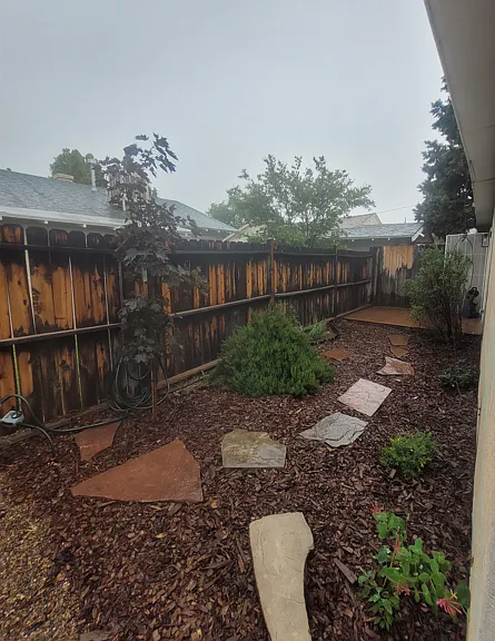 Private back yard with deck and plantings.