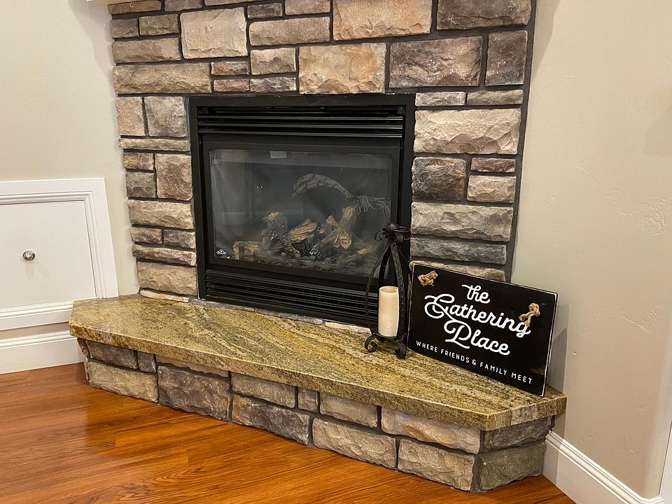 Fireplace with separate thermostat heats living room. Gas heating keeps utility costs down.