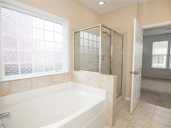 Oversized soaking tub and shower with ceramic tile
