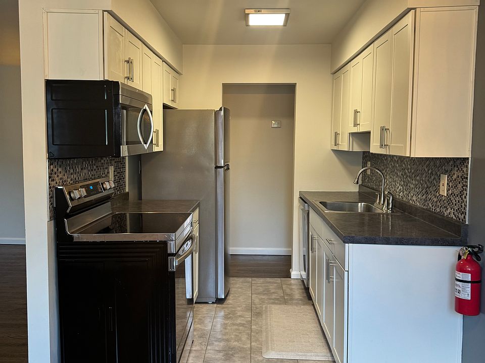 Galley Kitchen with Stainless Steel Appliances.