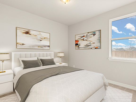 The third bedroom features plush carpet, neutral paint and a large window.