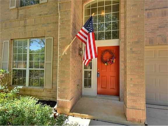 Bright front entrance, flag included.