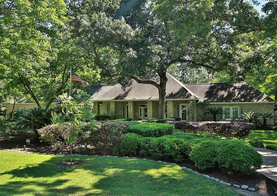Spectacular 1-story country estate home situated on a 2.13 acre wooded lot in prestigious Rolling Oaks!
