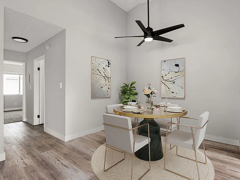 Hardwood floored dining room with view of second bedroom.