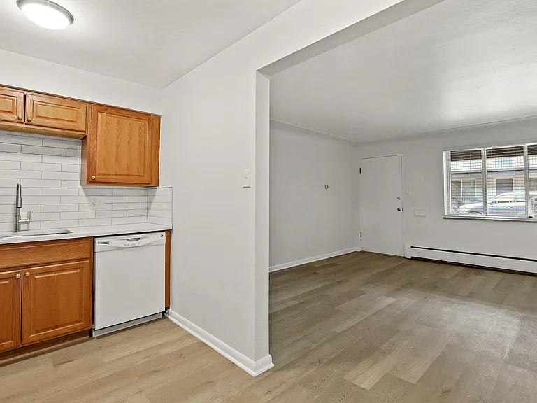 Bright, modern open-concept kitchen and living area with sleek wooden cabinetry and spacious light-filled interiors.
