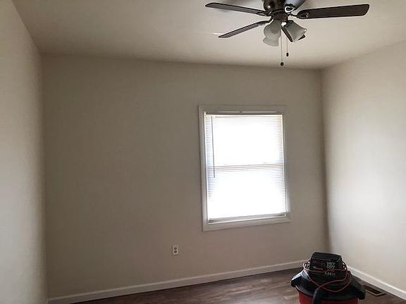 Bedroom, newly painted with new flooring and lighting.