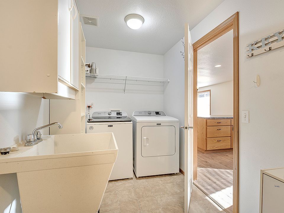Laundry room with Maytag washer & dryer included. Deep laundry sink.