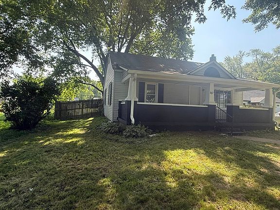 Another stunning view of the front of the home, showing the lush front yard and the true farmhouse chic.