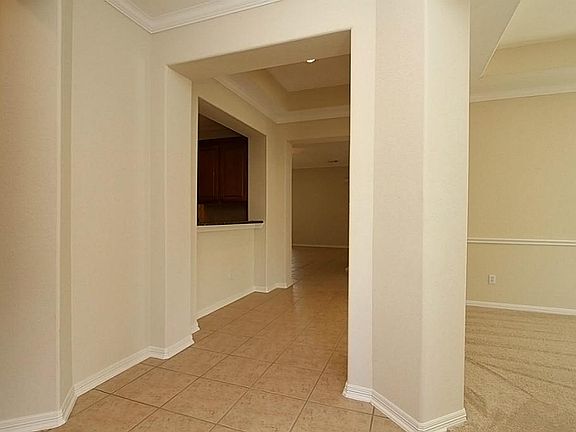 STARTING AT THE FRONT DOOR & ENTRY HALL, THE NEUTRAL CERAMIC TILE EXTENDS THRU A GALLERY WALKWAY AND INTO THE FAMILY ROOM, KITCHEN & BREAFKAST ROOM.  THE FORMAL DINING ROOM IS TO THE RIGHT OF THE ENTRY HALL AND IS CLOSE TO THE KITCHEN.