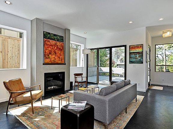 Looking west towards the patio area through Nana wall doors that fold completely open, offering a seamless transition from the living area to the outdoors. Great entertaining space. 