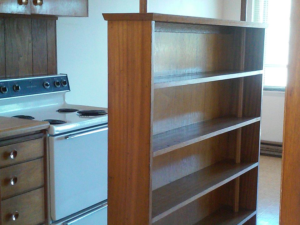 built in bookshelves separate the kitchen from living room but also gives an open feel.