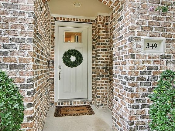 Gated entrance surrounded by lush landscaping.