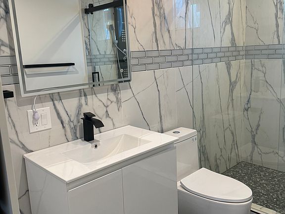 new modern bathroom with build in washer and dryer