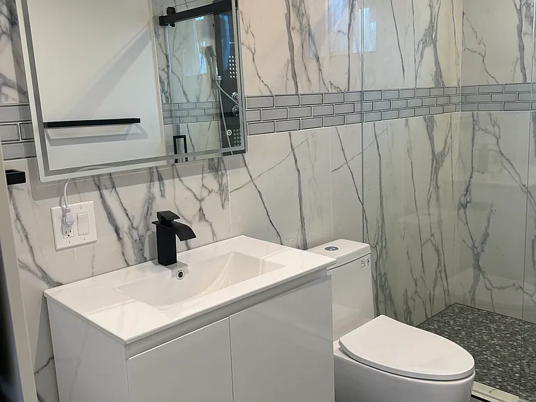 new modern bathroom with build in washer and dryer