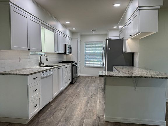 granite countertops; custom cabinets with lots of storage and built-ins