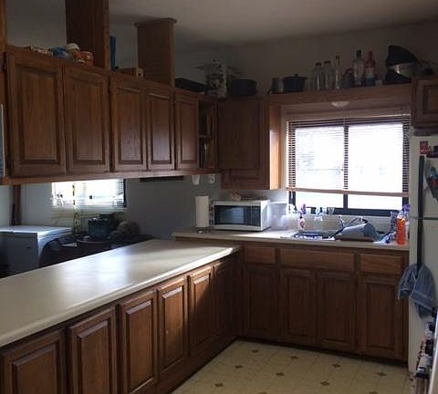 Large kitchen with lots of counter space and tons of cabinets.