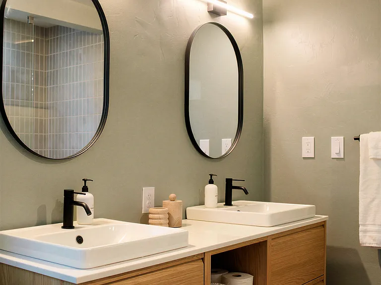 Double vanity bathroom with modern fixtures and ample storage in the primary bathroom.