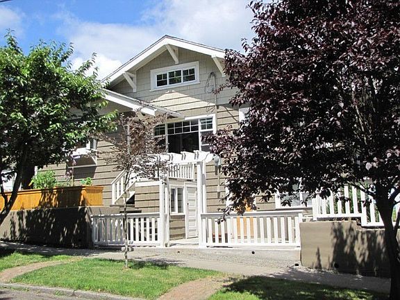 Side view of home with decks and entry to lower level