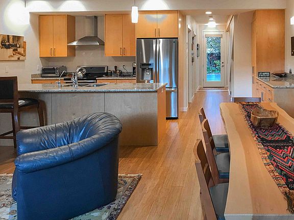 Looking from living room into the kitchen and down the hallway towards the front door.