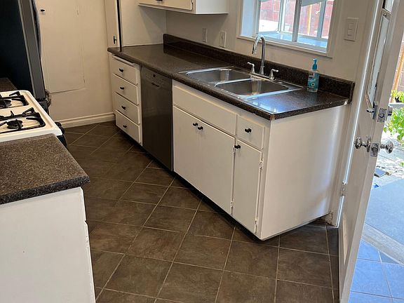 Kitchen opens to backyard. Brand new fridge and microwave