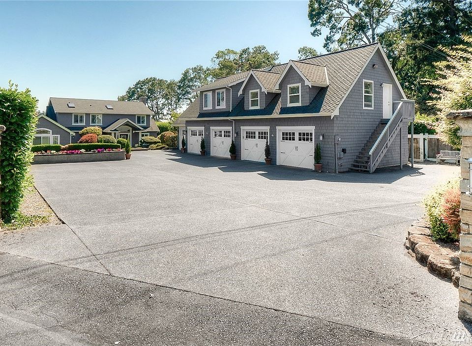 Amazing American Lake waterfront retreat. 3,651 sq.ft. finished plus 1,015 sq. ft. guest quarters over the 5 car garage.