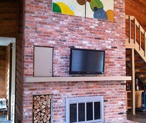 Huge vaulted living room with brick fireplace