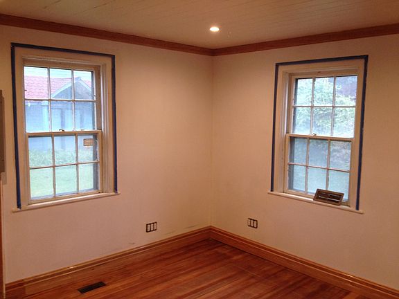 The 2 original windows in the bedroom bedroom have an additional 2 of glass us on the outside. Notice the hardwood baseboard trim and and Crown molding, Also there are 12 electrical outlets in this corner. Notice the recess lighting