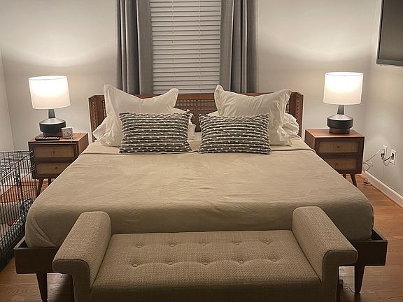Large master bedroom with custom closet and access to screened-in porch