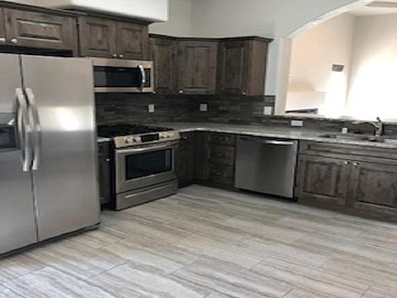 Stainless steel appliances with alderwood cabinets with soft close doors and drawers