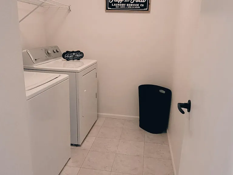 Large laundry room with full sized washer and dryer