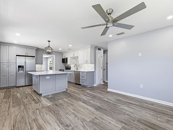 Kitchen with island. Brand new quartz countertops and cabinets.