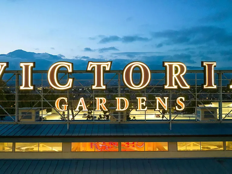 Victoria Gardens Sign Lit in Evening