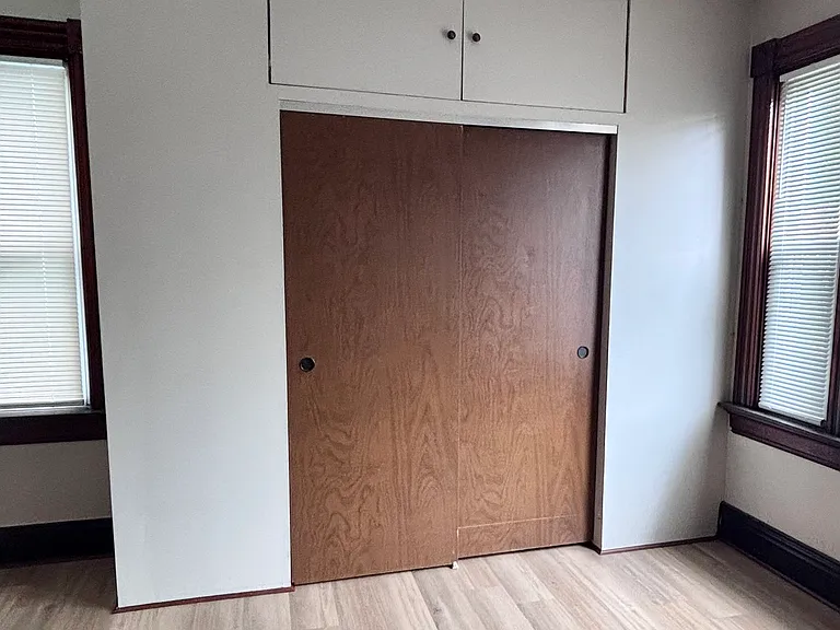 Oversized primary bedroom closet with double doors.