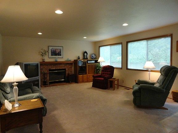 Big family room adjoins kitchen and becomes a mecca for evening activities. Log burning fireplace warms winter evenings, lots of naturel light.