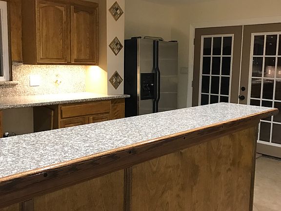 Fridge and doors that access backyard and back porch