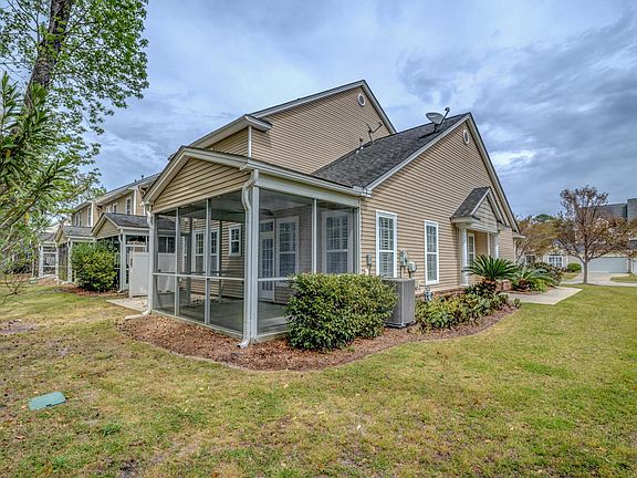Screened in porch and patio faces woods.