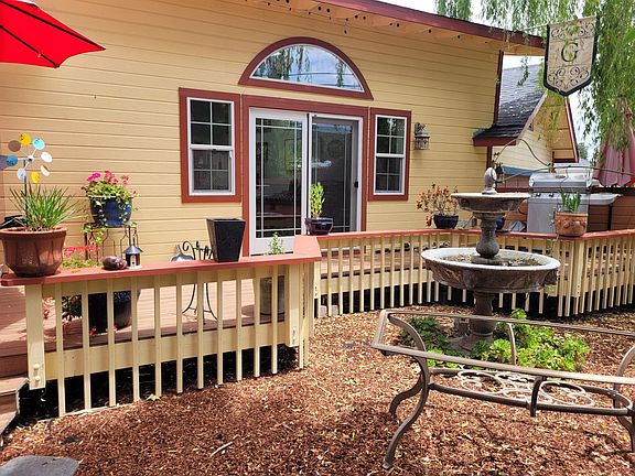 House front with deck/patio, water fountain
