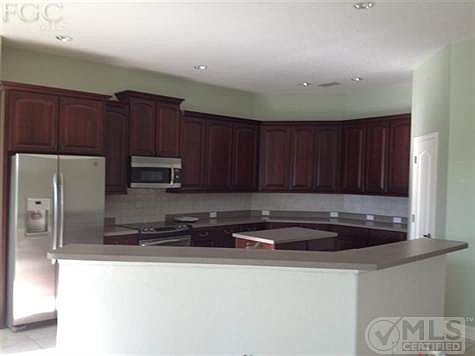 42 inch cabinets, stainless steel appliances, solid surface counters, huge bar