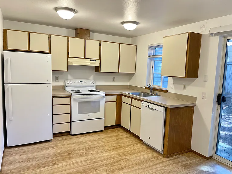 Kitchen includes eating area and slider to patio. Patio has locking storage area.