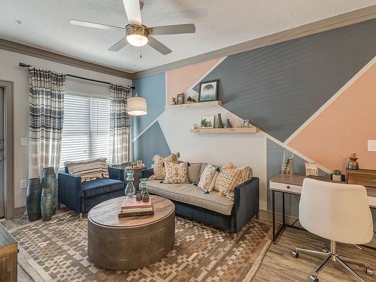 Living room with hard-surface flooring and ceiling fan