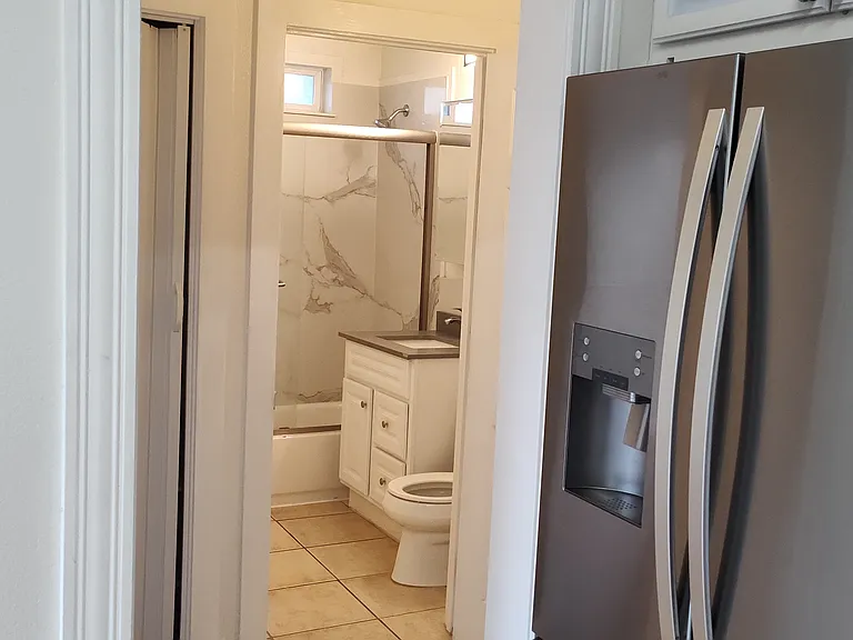 entry to hallway leading to bedrooms and bathroom