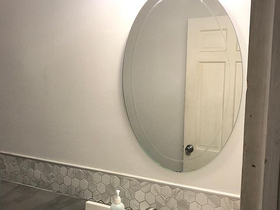 Completely restored bath with gorgeous tile accent.
