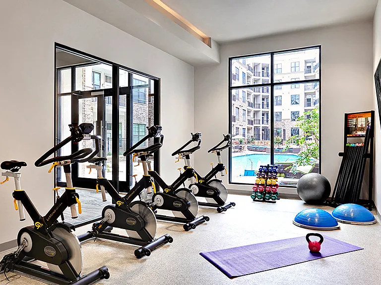 Separate fitness studio with on demand classes, including spin