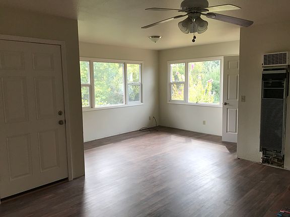 Upstairs living room. Exterior door on left to outside stairs. Door on right to interior stairs.