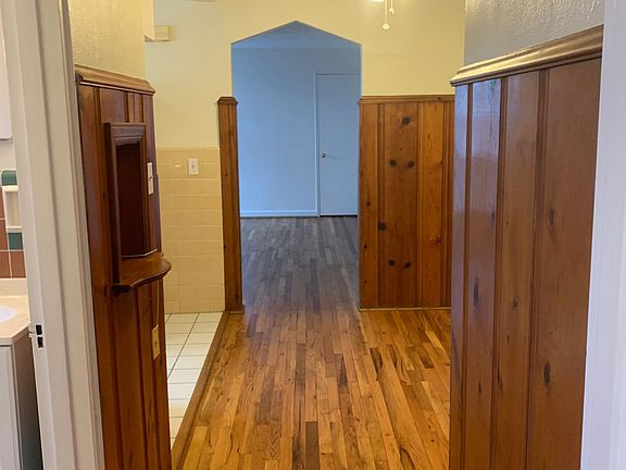 looking from bedroom to living area with kitchen on left