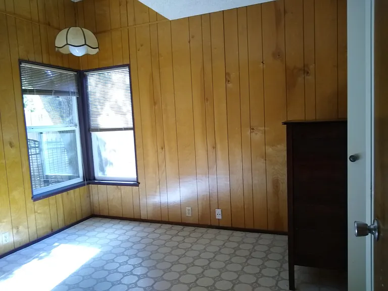First bedroom with corner windows.