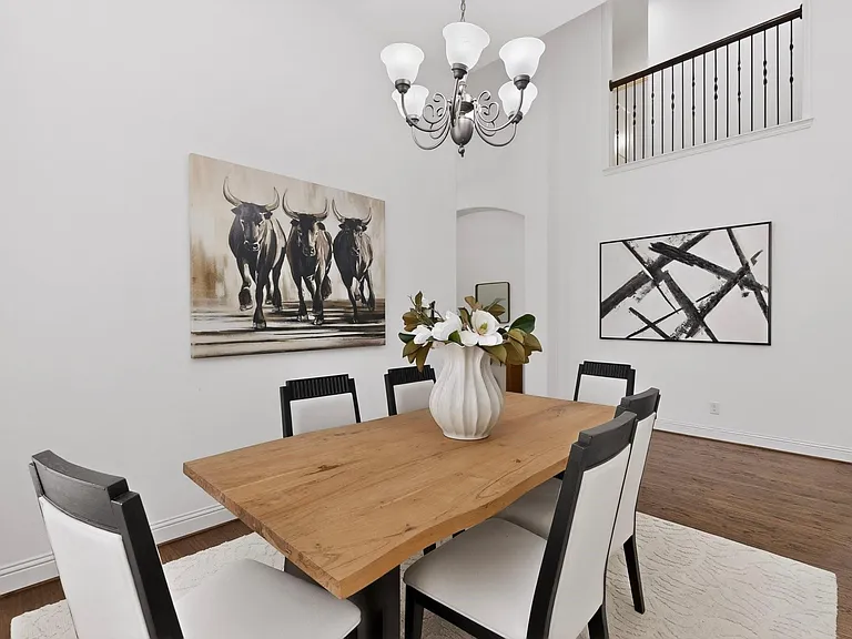 A bright dining area with a stylish chandelier, inviting for gatherings or meals.
