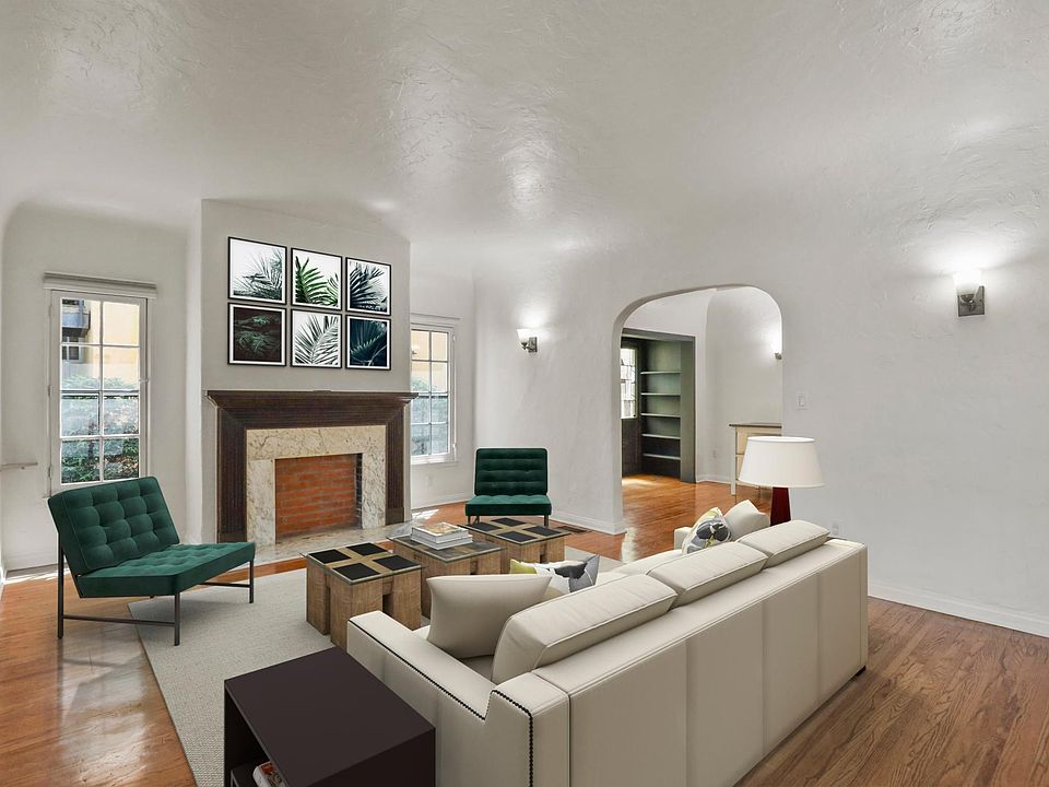 Spacious bright living room with tall vaulted ceilings.
